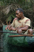 Pygmy fisherman cleaning up a fishing net