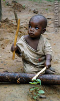 A Bakola-Bagyeli Pygmy child playing a struck idiophone