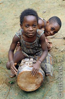 Bakola-Bagyeli Pygmy children playing a drum