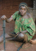 Baka Pygmy woman with a machete and a gathering pannier